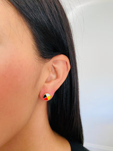 Woman wearing Medicine Wheel Earrings - a closeup on her ear.